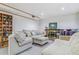 Basement living room with sectional sofa and brick fireplace at 1744 S Leyden St, Denver, CO 80224