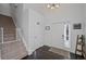 Bright entryway with staircase, coat closet, and wood floors at 6817 S Webster St # C, Littleton, CO 80128