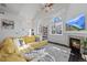 Living room with yellow sectional and fireplace at 6817 S Webster St # C, Littleton, CO 80128