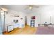 Bright bedroom features a ceiling fan, hardwood floors, a desk, and minimalist decor at 3071 S Truckee St, Aurora, CO 80013