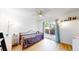 Bright bedroom features a ceiling fan, hardwood floors, and sliding glass door to the outside at 3071 S Truckee St, Aurora, CO 80013