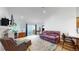 Bright living room with hardwood floors and access to the kitchen and backyard patio at 3071 S Truckee St, Aurora, CO 80013