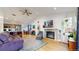 Open-concept living room with a fireplace, wood floors and a view of the kitchen and dining area at 3071 S Truckee St, Aurora, CO 80013