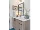 Bathroom with a modern vanity, framed mirror, decorative accents and blue tile floors at 2702 Lowell Blvd, Denver, CO 80211