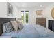 Bright bedroom featuring modern furnishings, neutral colors, and an abundance of natural light at 2702 Lowell Blvd, Denver, CO 80211