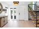 Bright entrance hall featuring a staircase with wooden steps and natural light from outdoor windows at 2702 Lowell Blvd, Denver, CO 80211