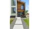 Inviting entrance featuring a modern door, tasteful wreath, and decorative planters leading to a stylish home at 2702 Lowell Blvd, Denver, CO 80211