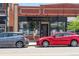 Street-level exterior of a building with brick facade and 'Highland Smiles' signage, storefront windows, and street parking at 2702 Lowell Blvd, Denver, CO 80211