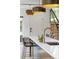 Modern kitchen with a bar seating island, stylish pendant lighting and staircase in the background at 2702 Lowell Blvd, Denver, CO 80211