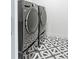 Laundry room with side-by-side washer and dryer on geometric tile floor at 2702 Lowell Blvd, Denver, CO 80211