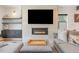 Modern living room featuring a fireplace, TV, and stylish gray sectional sofa at 2702 Lowell Blvd, Denver, CO 80211