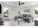 Living room with a comfortable gray sofa, modern decor, and access to an outdoor balcony at 2702 Lowell Blvd, Denver, CO 80211