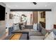 Spacious living room showcases an open layout into the kitchen with a comfortable gray sectional sofa at 2702 Lowell Blvd, Denver, CO 80211
