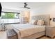 Cozy main bedroom with a tufted headboard, soft textures, and natural light at 2702 Lowell Blvd, Denver, CO 80211