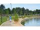 Vibrant park scene with a walking path, water feature, and locals enjoying a sunny day at 2702 Lowell Blvd, Denver, CO 80211