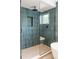 Modern shower with blue tile, a built-in bench, and glass enclosure at 2702 Lowell Blvd, Denver, CO 80211