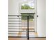 Open staircase with metal railings and a large window providing ample natural light at 2702 Lowell Blvd, Denver, CO 80211