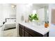 Bathroom featuring double sinks, modern vanity, and ensuite access to the bedroom at 8953 E Northfield Blvd, Denver, CO 80238