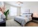 Bright bedroom with a queen bed, white bedding, and large windows at 8953 E Northfield Blvd, Denver, CO 80238