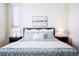 Cozy bedroom with a comfy queen bed, soft bedding, and bright natural light at 8953 E Northfield Blvd, Denver, CO 80238