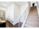 Bright entryway featuring modern stairs, wood floors, and convenient closet space at 8953 E Northfield Blvd, Denver, CO 80238