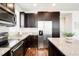 Well-equipped kitchen boasts stainless steel appliances, granite countertops and wood-look flooring at 8953 E Northfield Blvd, Denver, CO 80238