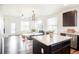 Open concept design with kitchen island blending into the living area at 8953 E Northfield Blvd, Denver, CO 80238
