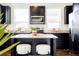 Beautiful kitchen island with granite counters, stainless appliances, and dark cabinets at 8953 E Northfield Blvd, Denver, CO 80238
