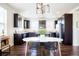 Modern kitchen with dark cabinetry, stainless steel appliances, and granite countertops at 8953 E Northfield Blvd, Denver, CO 80238