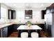 Modern kitchen with dark cabinetry, stainless steel appliances, and granite countertops at 8953 E Northfield Blvd, Denver, CO 80238