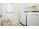 Efficient laundry room with modern washer and dryer, complemented by stylish decor and a practical storage basket at 8953 E Northfield Blvd, Denver, CO 80238