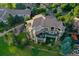 Expansive aerial view showcasing the luxury home, large deck, and meticulously landscaped yard at 2421 Ranch Reserve Rdg, Denver, CO 80234