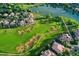 Lush aerial view of a neighborhood with a beautiful lake, golf course and luxury homes at 2421 Ranch Reserve Rdg, Denver, CO 80234