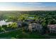 Expansive aerial view of luxury homes situated on a lush golf course with scenic ponds and mature trees at 2421 Ranch Reserve Rdg, Denver, CO 80234
