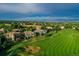Stunning aerial view of a golf course community with luxurious homes and lush greenery at 2421 Ranch Reserve Rdg, Denver, CO 80234