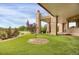 Landscaped backyard featuring a putting green and well-manicured garden beds at 2421 Ranch Reserve Rdg, Denver, CO 80234