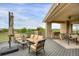 Spacious outdoor deck with plush seating and a built-in grill overlooking scenic views at 2421 Ranch Reserve Rdg, Denver, CO 80234