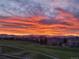 Scenic view of a colorful sunset over a golf course and neighborhood at 2421 Ranch Reserve Rdg, Denver, CO 80234