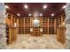 Well-organized wine cellar with beautiful wooden shelves and decorative stone accents at 2421 Ranch Reserve Rdg, Denver, CO 80234