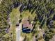 An aerial view showcases the cabin and outbuilding, with the driveway leading to the structure at 32252 Steven Way, Conifer, CO 80433