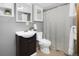 Bathroom featuring a sleek vanity with ample storage, a modern toilet, and a shower with a curtain at 32252 Steven Way, Conifer, CO 80433