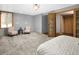 Spacious bedroom with neutral carpet, two chairs, and a double door closet at 32252 Steven Way, Conifer, CO 80433