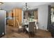 Bright dining area with bay window, wood floors, and open to the kitchen area at 32252 Steven Way, Conifer, CO 80433