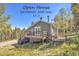Cozy two-story home featuring a charming deck and a lush, natural setting in a mountain area at 32252 Steven Way, Conifer, CO 80433