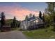 Charming two-story home with a deck, complemented by a picturesque sunset backdrop at 32252 Steven Way, Conifer, CO 80433