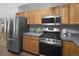 Modern kitchen featuring stainless steel appliances, ample cabinet space, and sleek countertops at 32252 Steven Way, Conifer, CO 80433