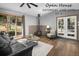 Cozy living room featuring a wood-burning stove, natural light, and comfortable seating at 32252 Steven Way, Conifer, CO 80433