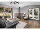 Cozy living room featuring hardwood floors, a wood burning stove, and large windows with natural light at 32252 Steven Way, Conifer, CO 80433
