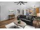 Spacious living room with stylish furnishings, wood floors, and seamless flow to the dining area at 32252 Steven Way, Conifer, CO 80433