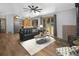 Inviting living room featuring a fireplace, wood floors, and expansive windows with views at 32252 Steven Way, Conifer, CO 80433